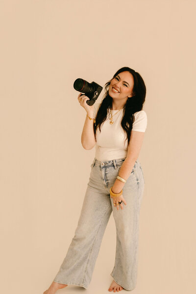 photographer posed with camera in her nashville tennessee photography studio