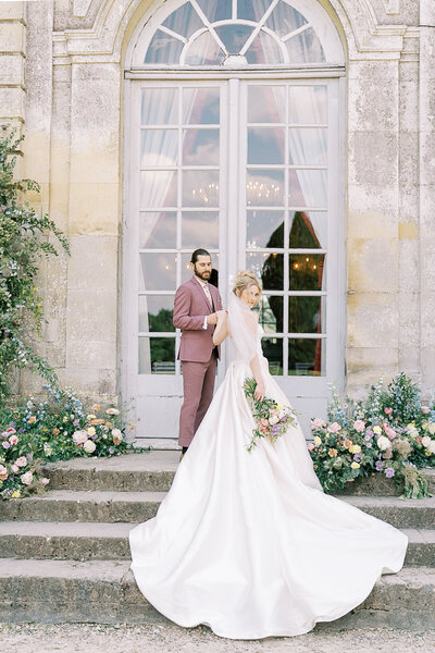 bride and groom outside chateau de champlatreux 