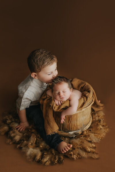 siblings with their newborn baby
