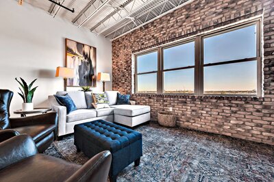 Living room with view of the Silos in this one-bedroom, one-bathroom rental condo in the historic Behrens building just blocks from the Magnolia Silos and Baylor University in downtown Waco, TX.