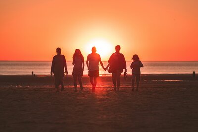 Family connecting after family therapy on the beach.