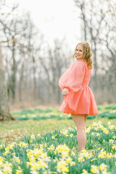 Teen girl standing in the daffodils by Chicago Senior Photographer Kristen Hazelton