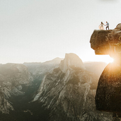 couple looking over edge off a mountain cliff