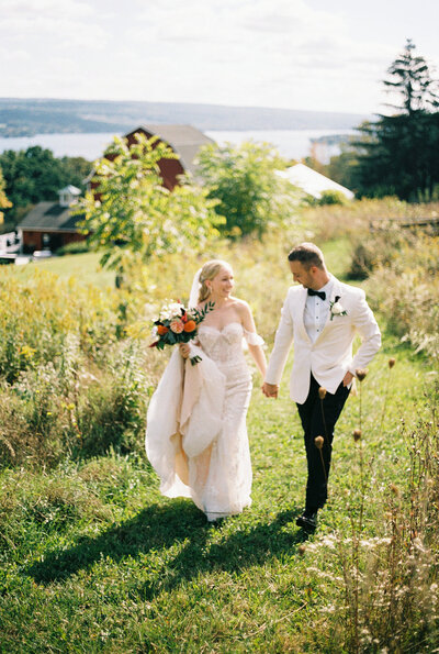 brides holding hands at finger lakes wedding in New York