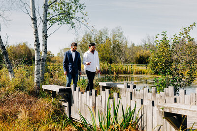 Groom and officiant walking near pond at Sky Ridge Ranch in Ronan, MT