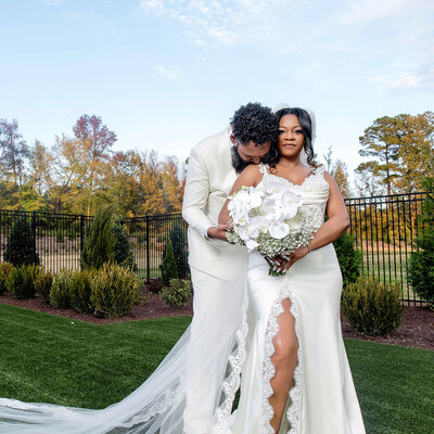 Romantic outdoor wedding portrait of the newlyweds at a stunning Raleigh venue.