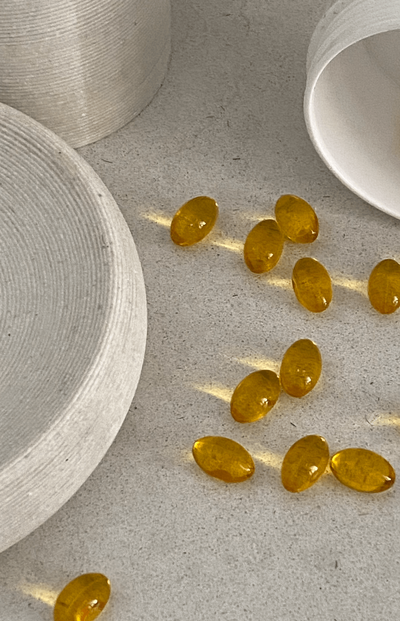 Close-up of nutritional gel capsules on a countertop, highlighting high-quality supplements available at Love Light Wellness Kauai