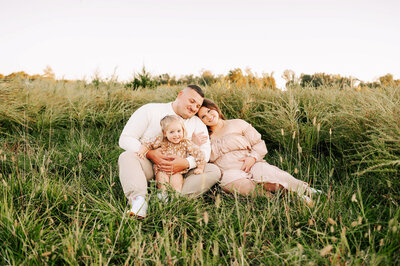 pregnant mom laughing with family during Springfield Mo maternity photography session