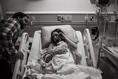 black and white photo of a woman yawning after giving birth