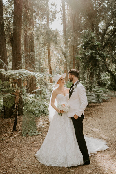 bride and groom posing in forest