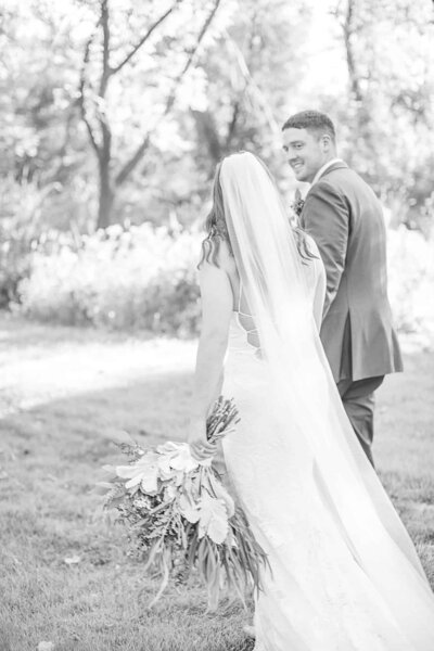 Bride and Groom walking away from camera during wedding at The Abbey Resort