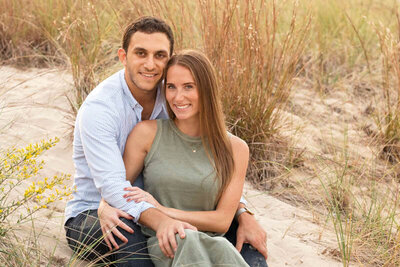 Smiling couple on sandy dune in Indiana