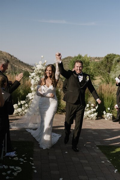 Bride and groom celebrate after their Colorado wedding ceremony