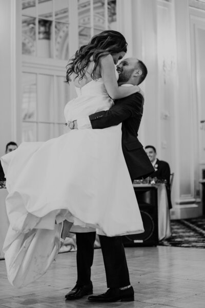 Groom lifts bride in first dance