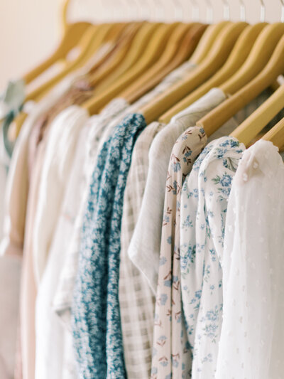 A curated selection of women's dresses in a photography client closet