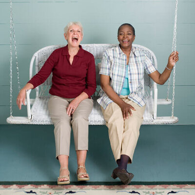 Photo of two women on a porch swing
