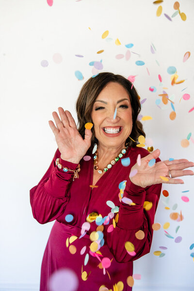 On call stylist in Springfield, MO throwing colorful confetti