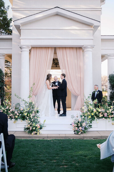 Spring wedding ceremony at the Huntsville Botanical Gardens with pastel flowers. Photo Taken by Eric and Jamie Photo from Birmingham, AL.