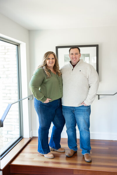 A warm and personal shot of Meg Williamson posing with her husband, a real estate agent based in Indiana. The image reflects their close partnership and shared dedication to the real estate and photography industries.