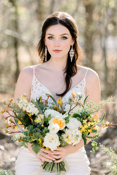 Bridal Portrait with sunny spring bouquet  outside at White Fox cottage wedding venue in Commerce Georgia