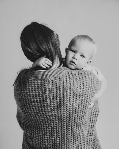 photo of a mother holding a son in a studio portrait