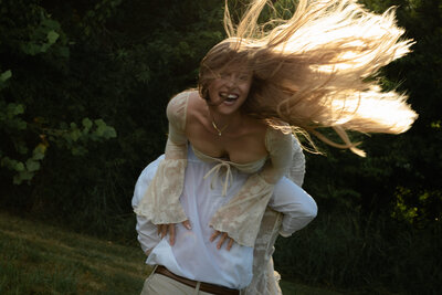 Playful candid moment during couples session with genuine laughter and cinematic tones.