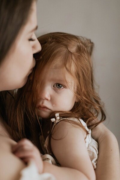 Tender moment with mom and child by traverse city photographers