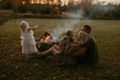 Family enjoying a bonfire during their session in Kitchener, Ontario.
