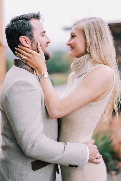 Couple smiling and holding each other after getting engaged
