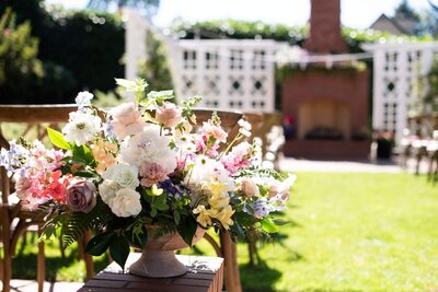 A large floral centerpiece at a wedding, representing wedding flowers designed by Eugene florist, Flowers and Thyme.