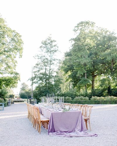 Wedding head table with neutral french bistro chairs, plum tablecloth, and silver candelabras, photographed by New England Wedding Photographer Ashley Helen