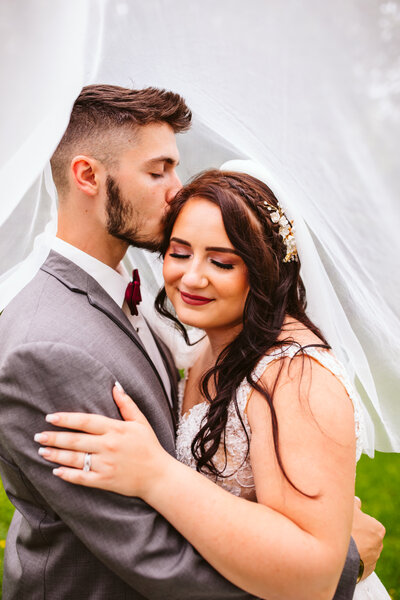 Bride and groom kissing under the veil - Bemidji, Minnesota