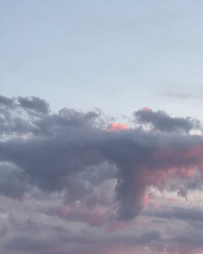 pink and purple vibrant sunset with fluffly clouds