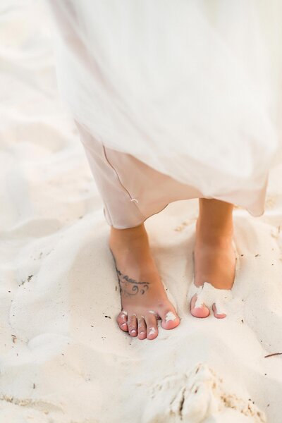 Image of a bride walking in the sand of new mexico taken by wedding photographer Carissa and Ben Photography.