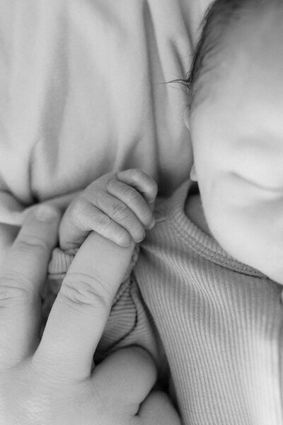 A family snuggles together for a group hug while laying for a candid moment