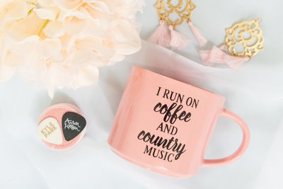 Pink coffee cup and earrings flatlay