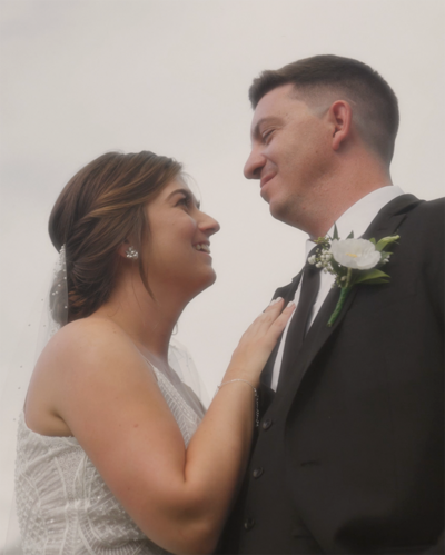 Bride and groom looking at each other smiling