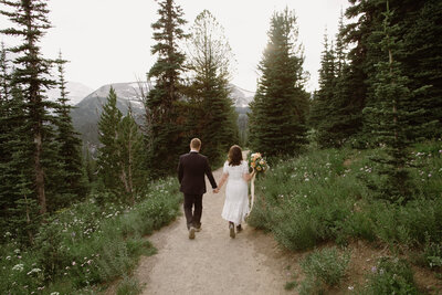 Couple walking along a trail in the mountains.