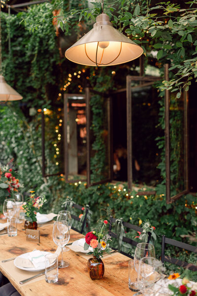 Elegant table setting with floral arrangements at Kellen and Paul's intimate wedding dinner celebration in New York City.