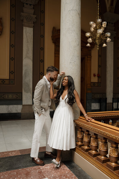 Bride standing on a bridge having wedding portraits done