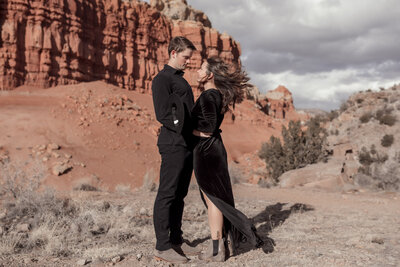 couple embracing in front of mountain