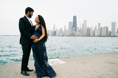 Couple standing in front of Chicago Skyline by Lake Michigan