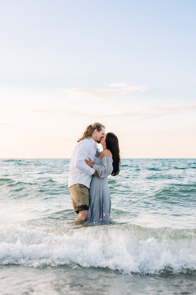 Couple embracing in the waves in Northern Micihgan