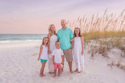 family-of-five-posing-by-the-dunes-on-navarre-beach
