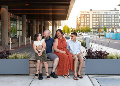 Family sitting in front of AC Marriott near Portland, Oregon. Photo by Portland family photography.