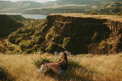 girl in white dress standing next to waterfall in columbia river gorge