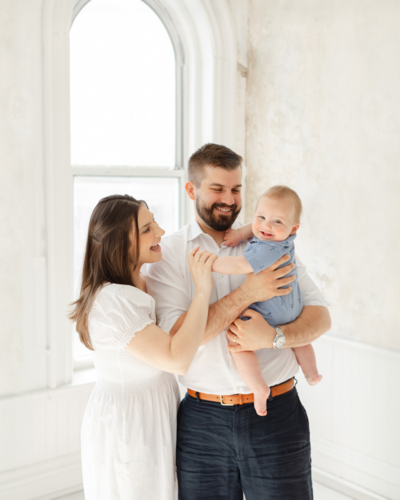 young couple holds their 6 month old baby during boston photoshoot
