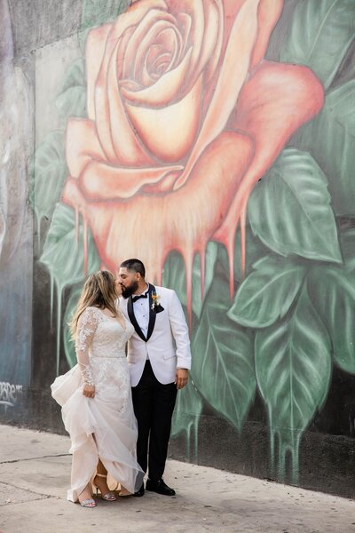 couple posing by murals