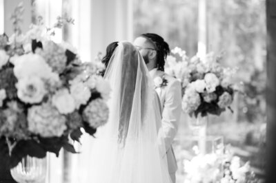 A couple with closed eyes embracing at Arthur Blank Foundation in Atlanta, GA
