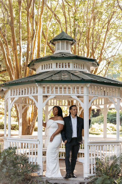 gainesville fl couple posing for engagement session under trees